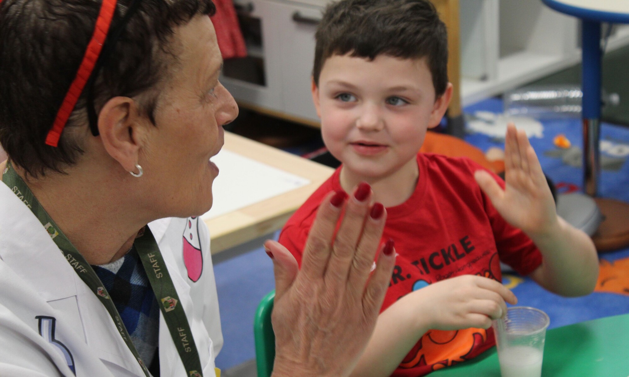 Child talking with teacher